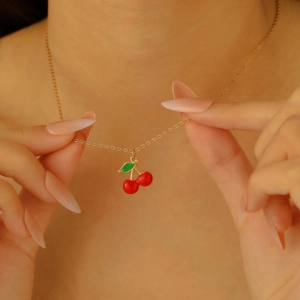Exquisite gold cherry pendant necklace with red crystals on a delicate link chain