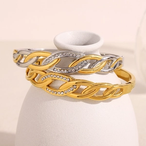 Close-up of interlinked 18K gold-plated bangles with sparkling zircon pave details