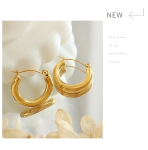 Detail of 18K gold plated chunky hoop earrings with a high-polished mirror finish