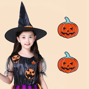 Detail of two classic orange enamel pumpkin pins with Jack-o'-lantern faces and girl wearing it
