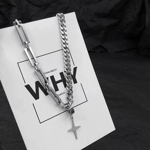 Silver star cross necklace with mixed cuban and square links on a display card