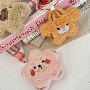 Detail of plush star charms with embroidered animal faces and small metal bells