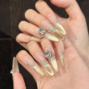 Luxuriöse goldene Katzenaugen-Drucknägel mit glitzernden Verläufen und Kristall-Strass