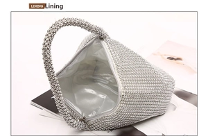 Detail of silver rhinestone clutch showing internal shiny satin lining and zipper closure