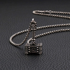 Detail of vintage Mjolnir pendant in silver stainless steel on textured black leather
