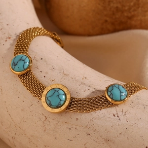 Macro shot of 18K gold mesh chain bracelet with blue turquoise and Roman numeral detail