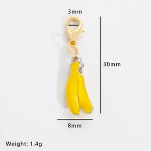 Banana pendant with yellow enamel and gold clasp, showing 30mm height and 1.4g weight