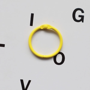 Yellow painted metal binder ring for DIY keychains and creative office stationery