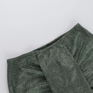 Detailed macro view of dark green shimmering metallic fabric with high-reflectivity texture