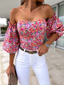 Detail of floral off-shoulder top featuring puffy sleeves and slim fit corset design