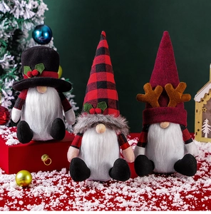 Close-up of three festive Christmas gnomes with plaid hats and reindeer antlers decor