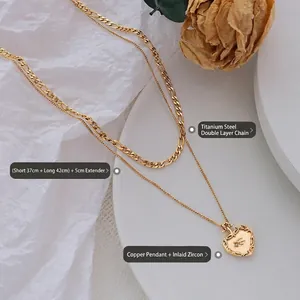 Collier double rang en acier titane avec pendentif cœur doré et zircons