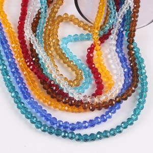 Close-up of colorful faceted crystal rondelle beads arranged in a layered U-shape