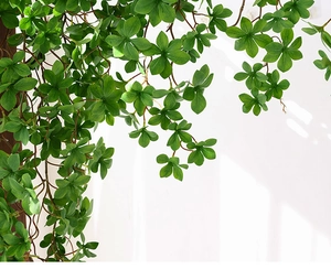 Close-up of artificial hanging vines with realistic green leaves for wall decoration