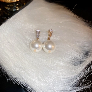 Elegant gold drop earrings featuring large round pearls and sparkling zircon accents