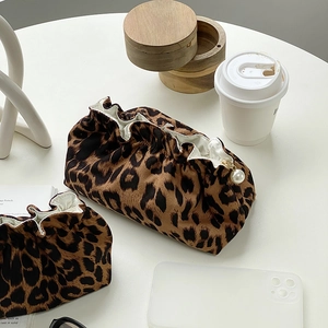 Detail of leopard print makeup bags with soft texture, drawstring and pearl pendant