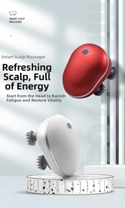 Detail view of electric head massager with four rotating claws and dual-color metallic finish