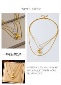 Detail view of double-layer gold plated snake bone chain with blue and gold heart charms