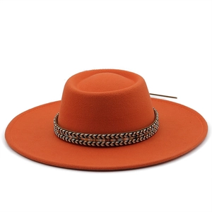 Detail view of orange wool fedora with a colorful geometric ethnic pattern ribbon band