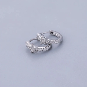 Detailed macro view of S925 sterling silver star hoop earrings with zircon crystals