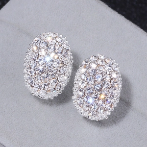 Elegant silver oval stud earrings featuring brilliant white zircons on grey velvet base