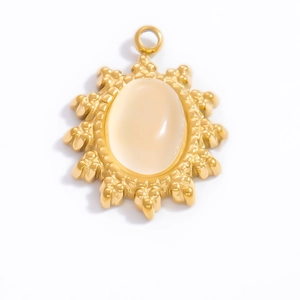 Detailed macro view of 18k gold sunburst pendant with translucent natural gemstone inlay