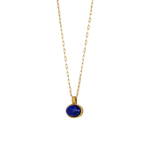 Detailed view of vintage gold chain necklace with oval lapis lazuli gemstone pendant