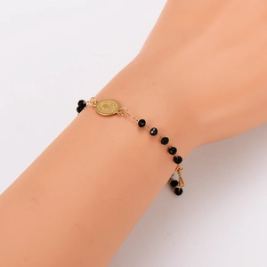 Religious beaded bracelet with black faceted beads and a gold St. Benedict medal charm