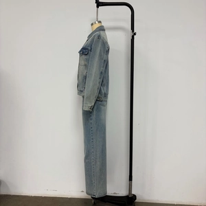 Side view of light blue denim utility jacket and straight leg jeans set on a mannequin