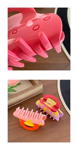 Detailed macro view of colorful acetate hair claws with polka dot patterns and metal spring