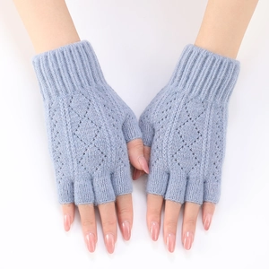 Detail of light blue knit arm warmers with diamond pattern and ribbed fingerless cuffs