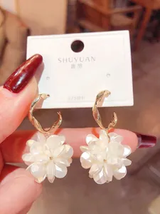 Detailed view of handmade white layered petal flower earrings with 925 silver needles