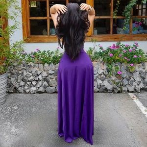 Detail of the backless design and silky purple fabric on a long sleeveless dress
