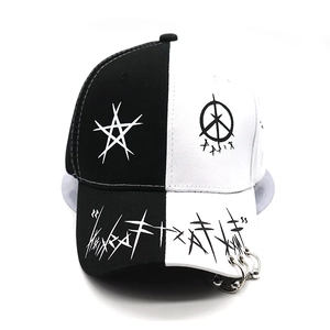 Detail of hip-hop baseball cap with graffiti print brim and silver metal rings decoration