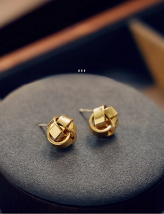 Gros plan de boucles d'oreilles nœud torsadé plaqué or en laiton de qualité