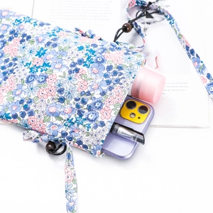 Floral drawstring mobile phone bag with wooden beads showing storage for cosmetics and pens