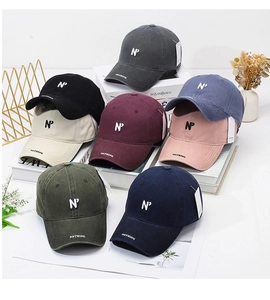 Detailed stack of multi-color washed cotton baseball caps with embroidered N logo