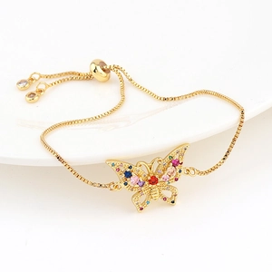 Detail of adjustable gold box chain bracelet with colorful zircon butterfly charm