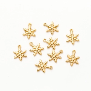 Set of eight 18K gold-plated snowflake charms for DIY jewelry making on white background