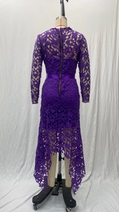 Detail of purple lace dress with slim fit, back metal zipper, and irregular hemline