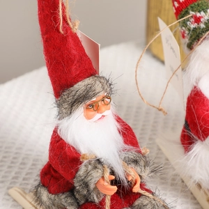 Santa Claus figure on wooden sleigh with red felt costume and golden glasses decoration