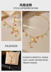 Macro detail of gold celestial Y-necklace with sun, moon, and star charms and beads
