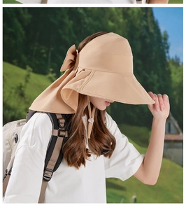Detail of beige sun hat featuring a large brim, neck flap and elegant bow decoration