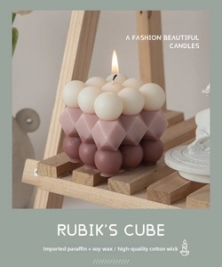 Detailed view of handmade cube candle crafted from soy wax and paraffin in purple gradient