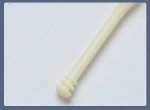 Macro detail of the dual-head nose hair trimmer featuring a beige textured spiral tip