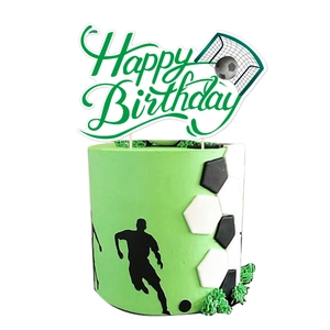 Green Happy Birthday cake topper with football and goal patterns on a soccer-themed cake