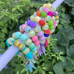 Colorful silicone bead bracelet keychain with PU tassel in outdoor natural setting