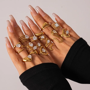 Macro shot of gold boho ring set featuring zircon stones and snake-shaped designs