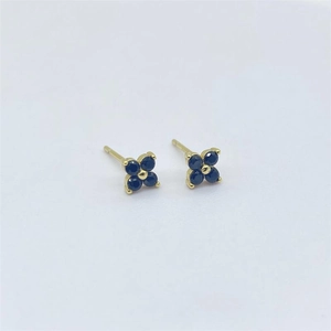 Detail view of S925 sterling silver four-leaf clover stud earrings with deep blue stones
