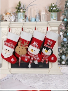 Detail of four knit Christmas stockings with 3D Santa, Reindeer, Snowman and Penguin figures